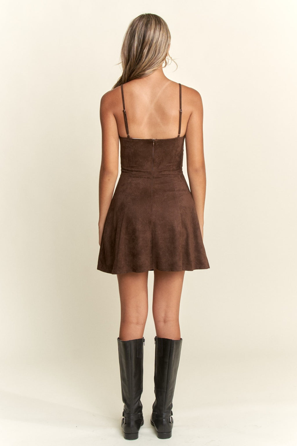 Brown dress worn by a person on a beige background