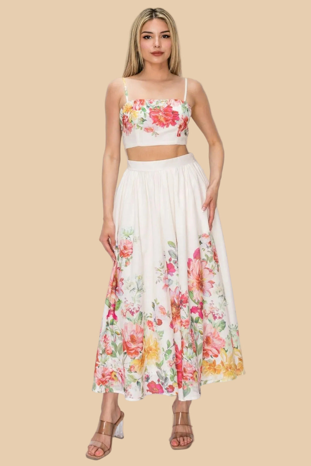 Woman wearing a floral two-piece outfit with a white background