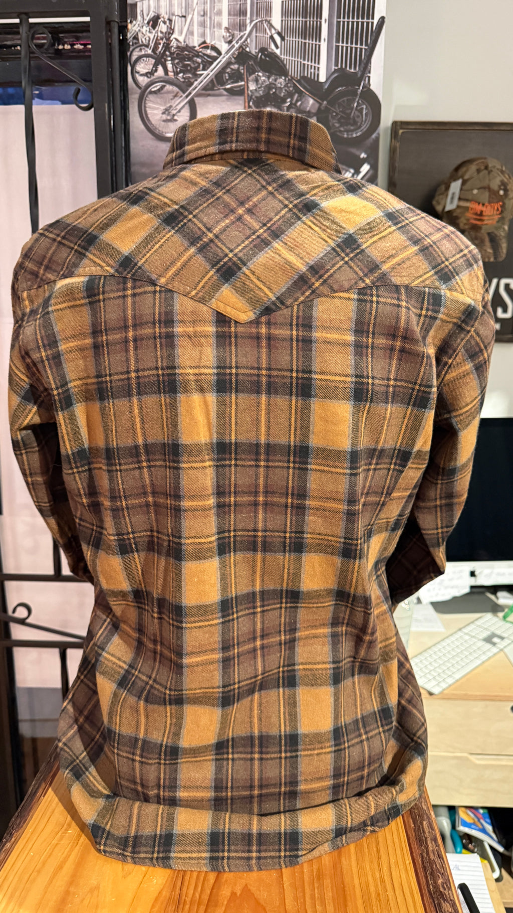 Plaid shirt on a mannequin against a casual indoor background