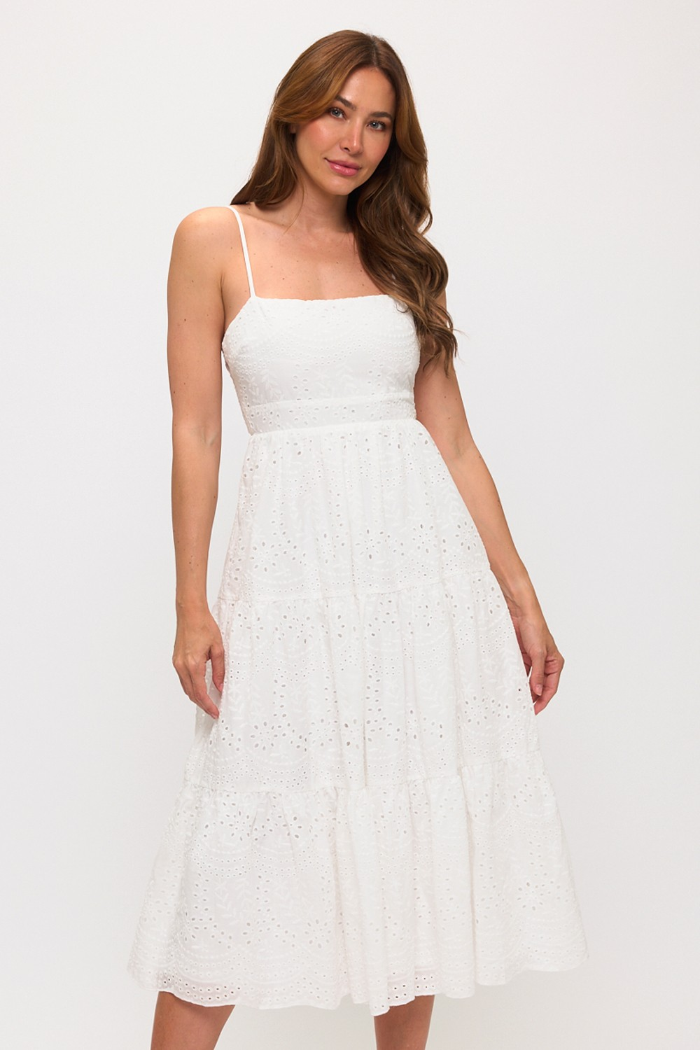 Woman wearing a white lace dress against a white background