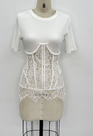 White lace top over a plain white shirt on a mannequin against a light gray background