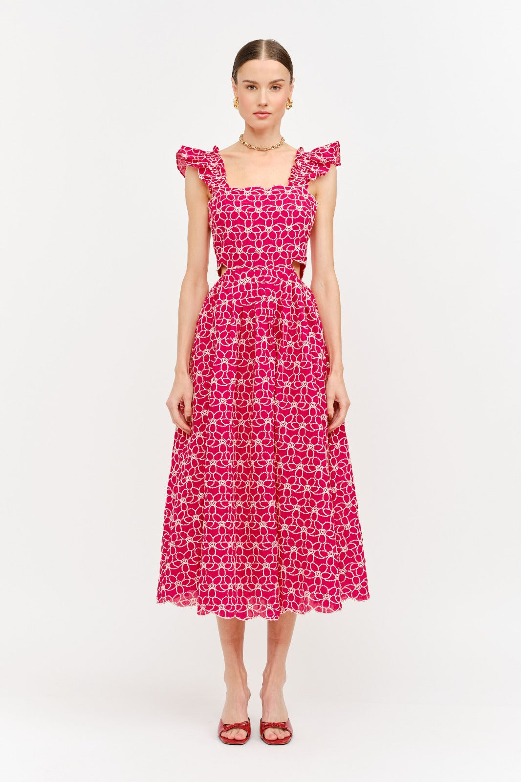 Woman wearing a pink floral dress on a white background