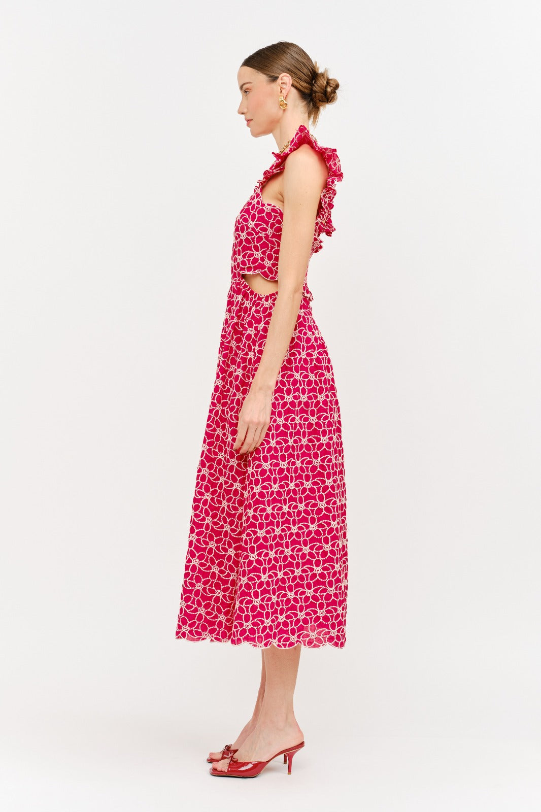 Woman wearing a pink floral dress on a white background