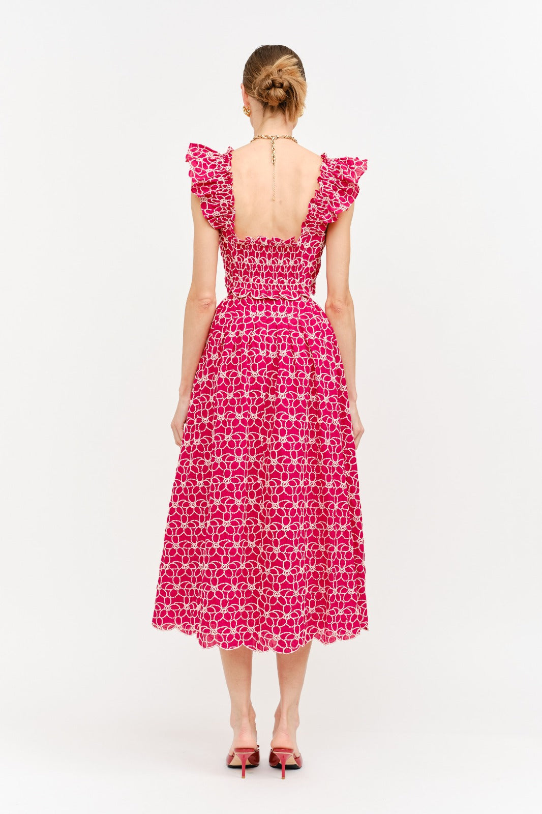 Woman wearing a pink floral dress on a white background